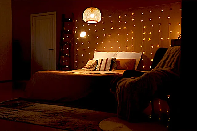 bedroom with fairy lights around the bed