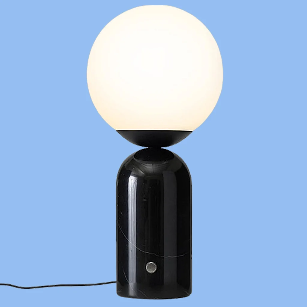 Image of a black marble table lamp with a white globe light