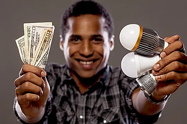 a happy man with dollars & LED bulbs showing his savings using LED bulbs