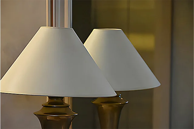 pair of brass table lamps with white lampshades